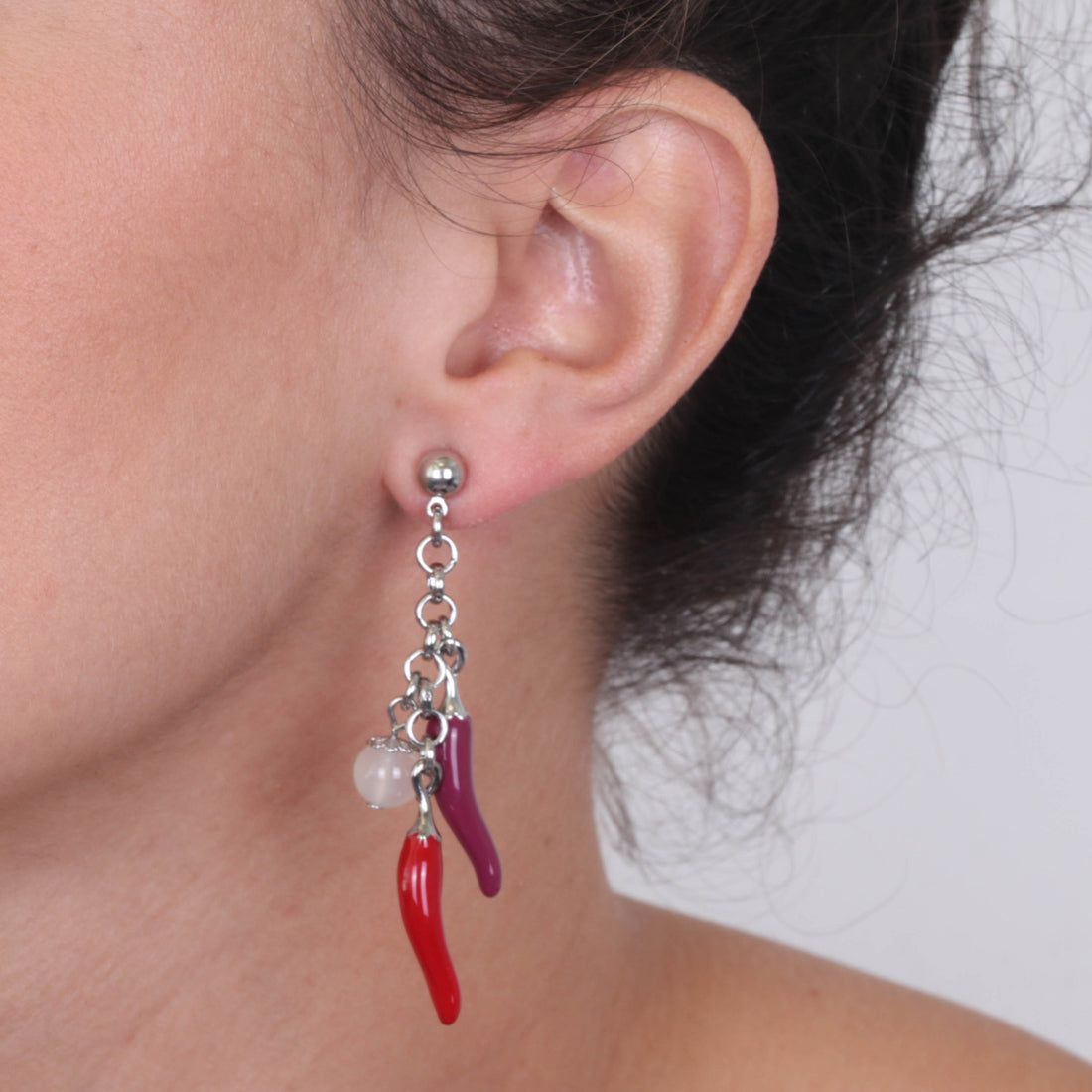 Metal earrings pending with lucky horns, embellished with colored glazes
