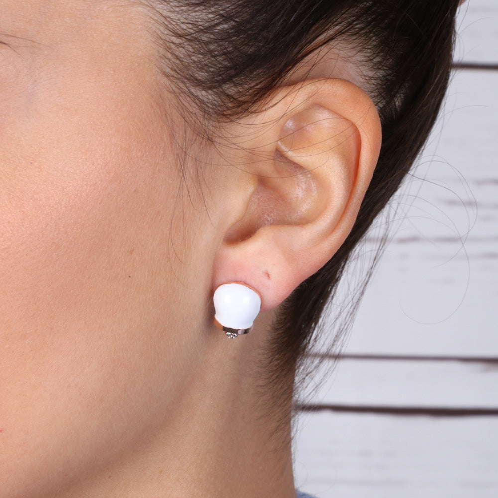 Metal earrings in the shape of a charming bell with white glazes and crystals