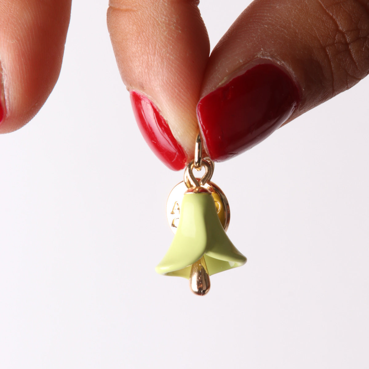 Metal pendant bell in the shape of a calla embellished with colored glazes
