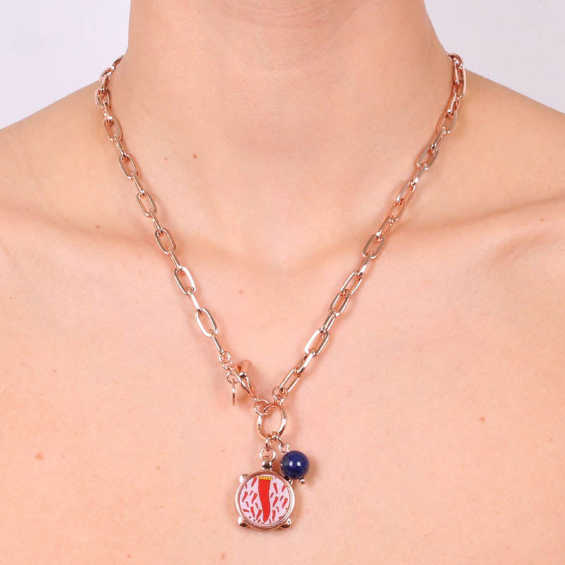 Metal necklace with pendant drum and red enamel horn design