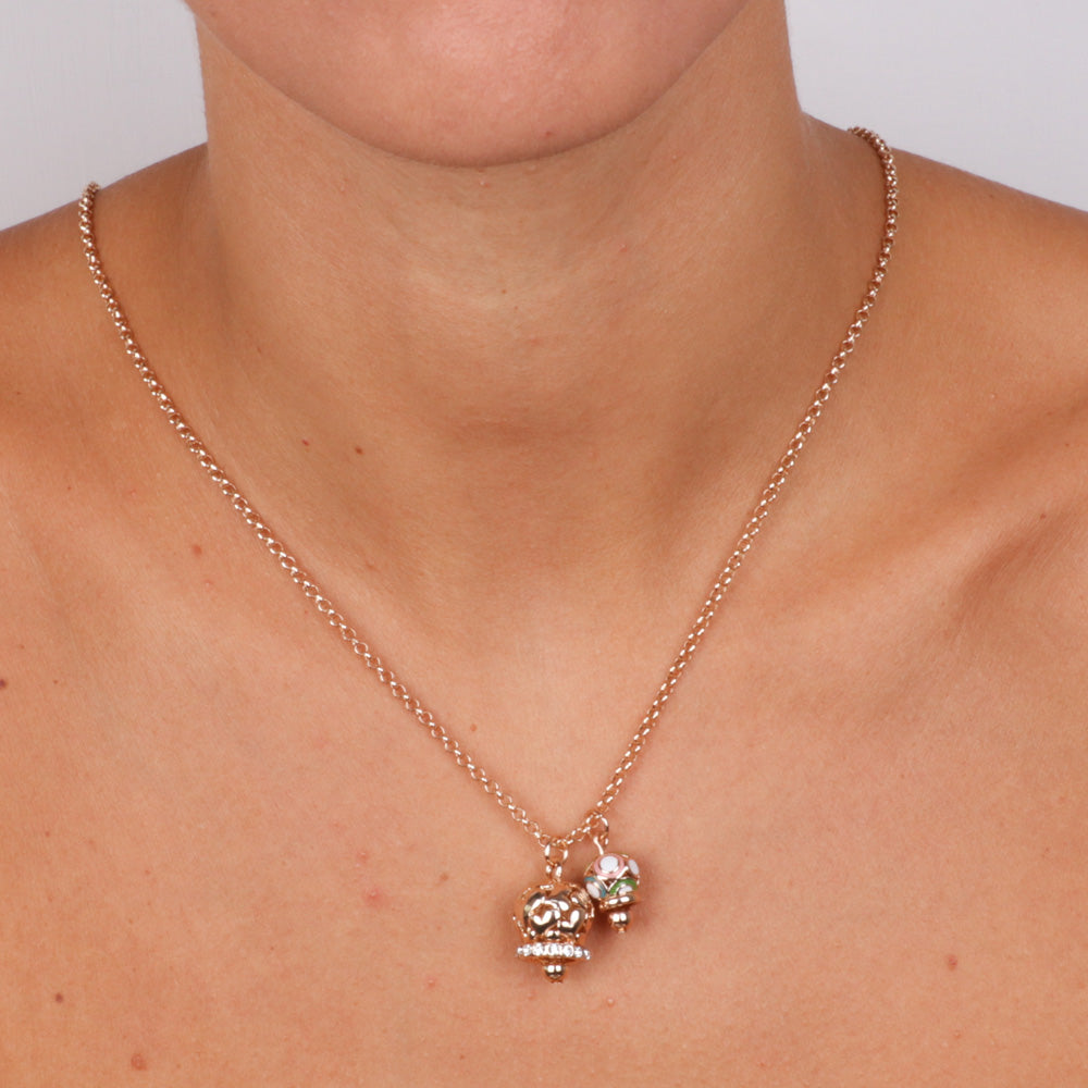 Metal necklace with bell from pierced bell with hearts with white crystals and small colored bell