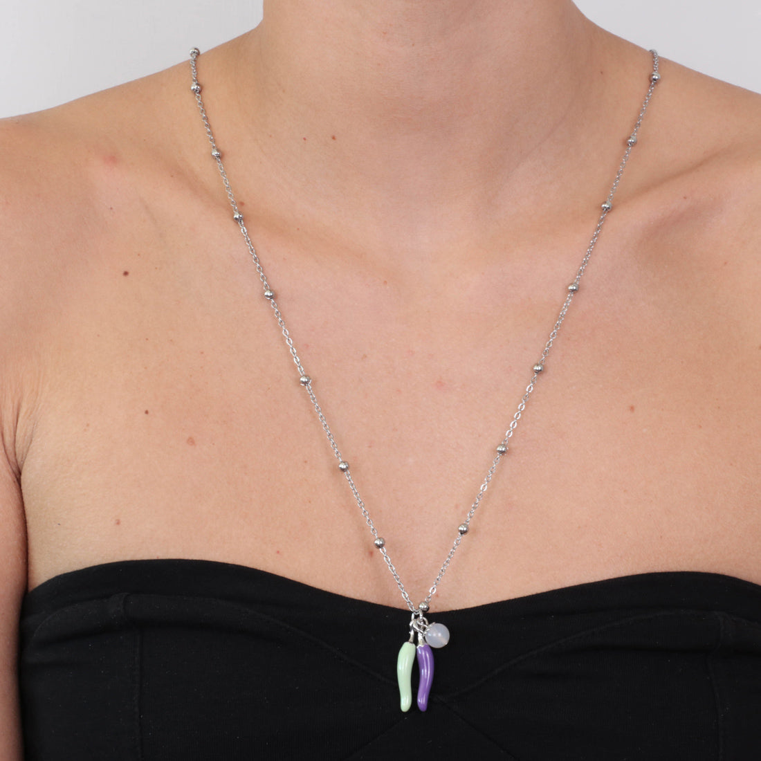 Metal necklace with pendant luck charms, embellished with colored glazes