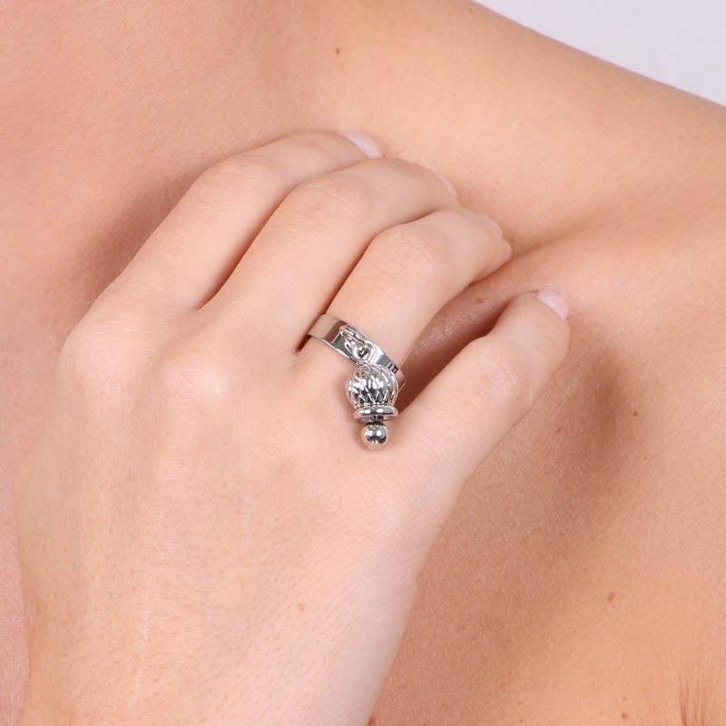 Metal ring with pendant charm bell, weave motive motif