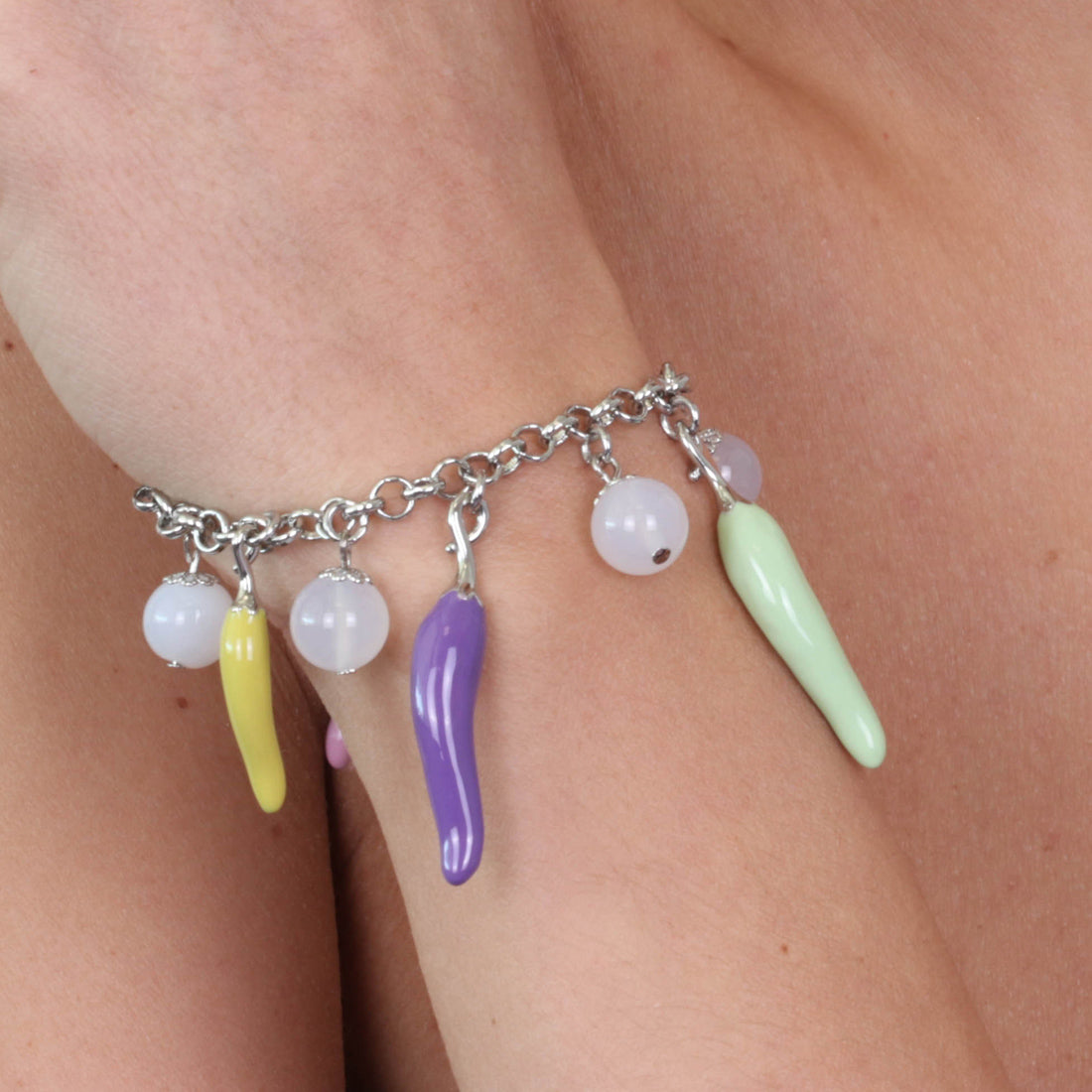Metal bracelet with pendant luck charm cornies, embellished with colored glazes