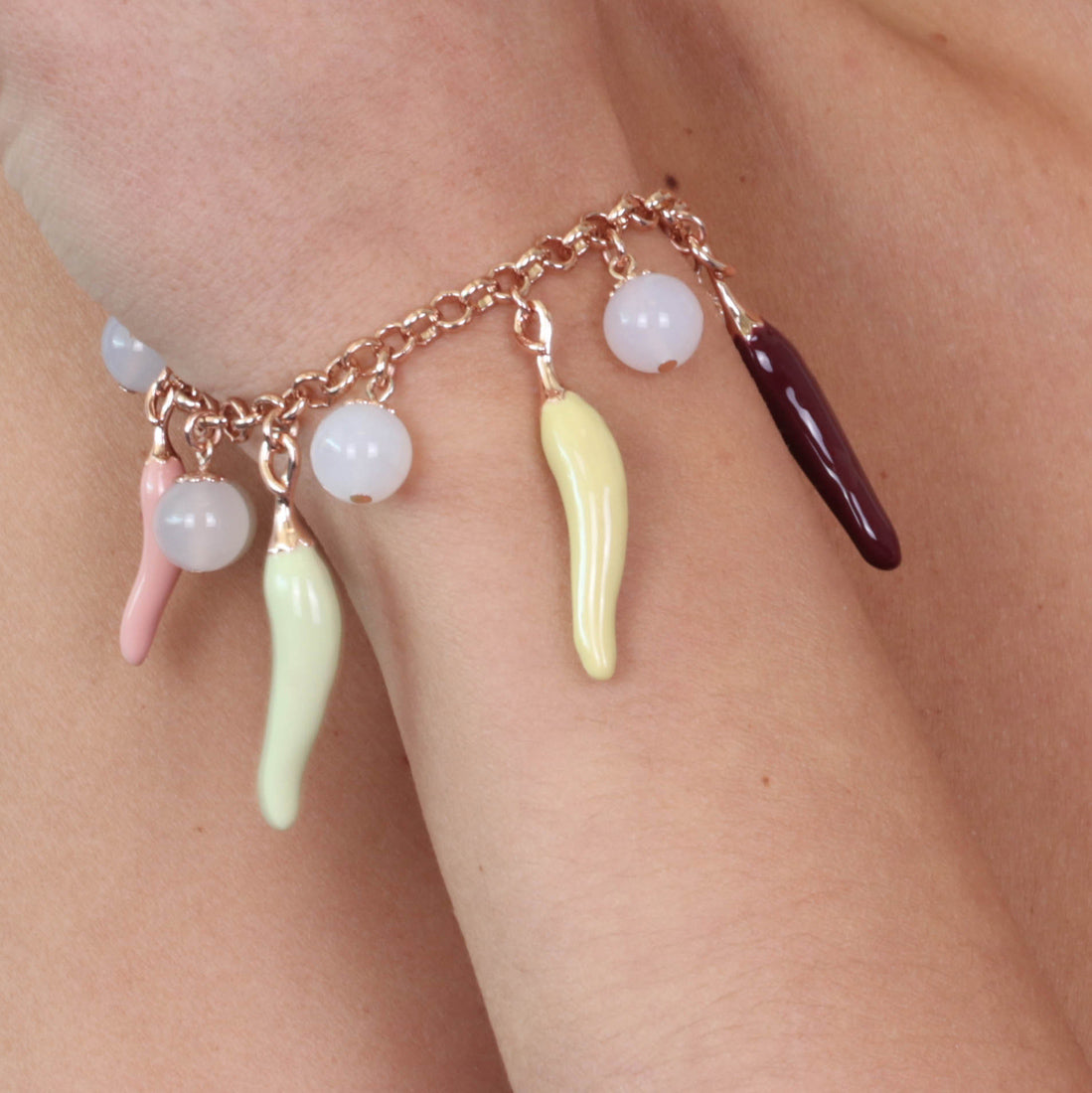 Metal bracelet with pendant luck charm cornies, embellished with colored glazes
