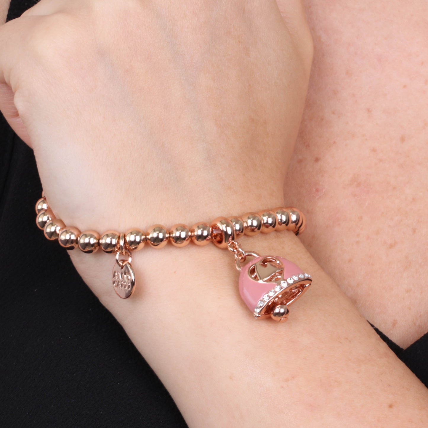 Metal bracelet with pink bell and central design Faraglioni
