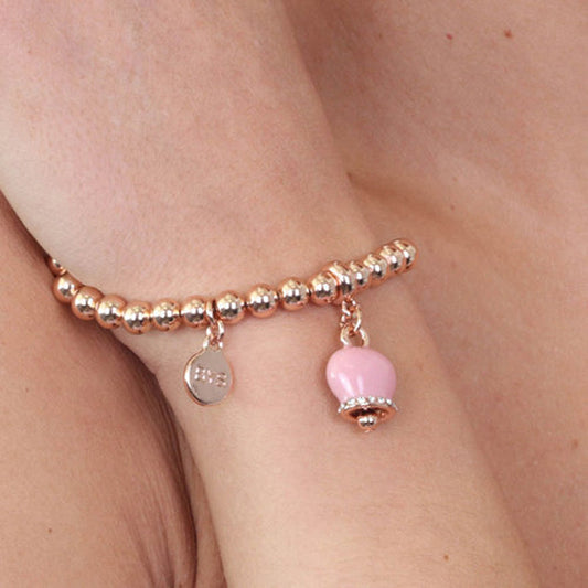 Metal bracelet of ball jersey, with a pendant charm bell, embellished with pink enamel and crystals