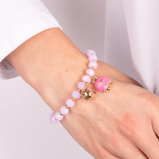 Metal bracelet with fuchsia bell and small rattle with pink stones