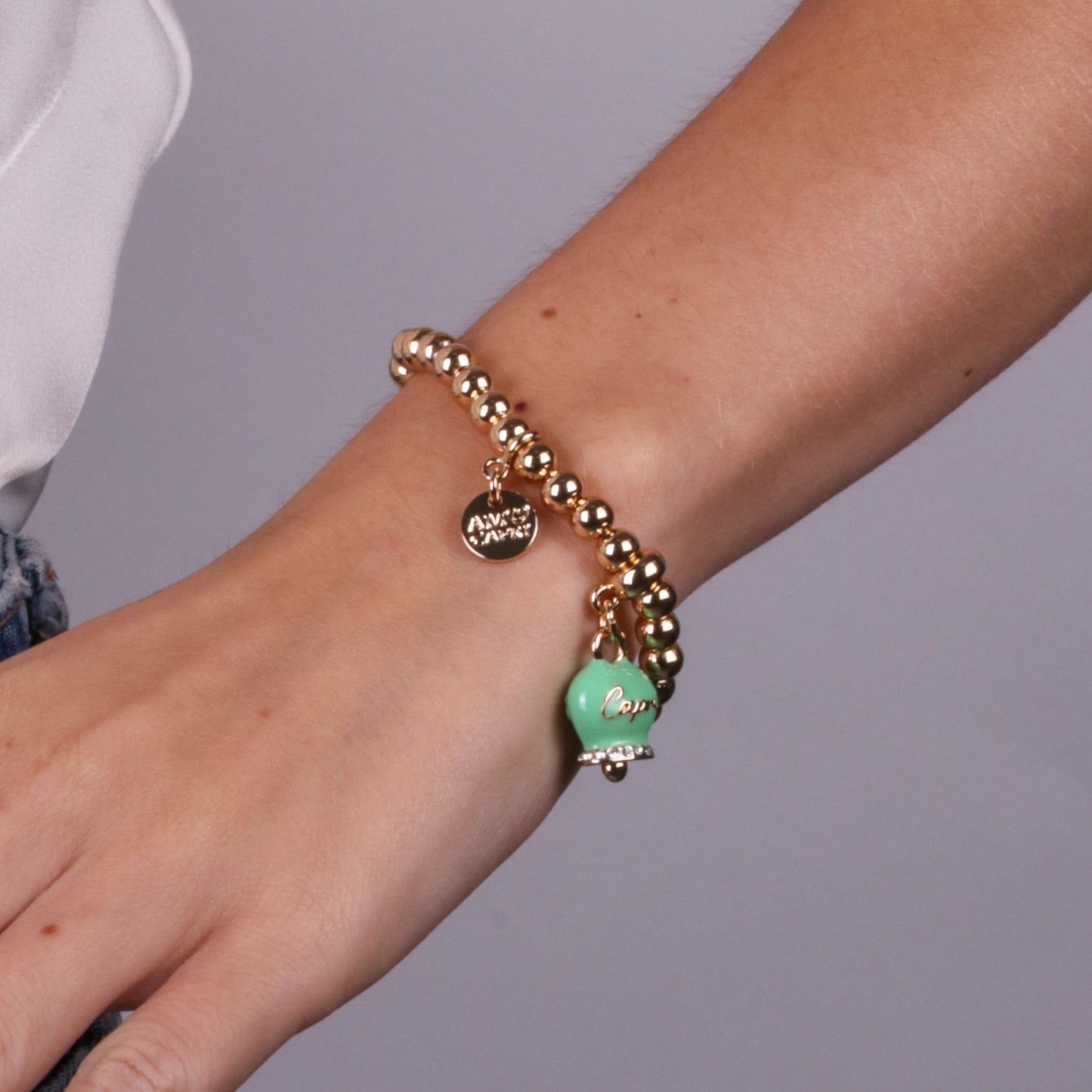 Metal bracelet with green bell written Capri