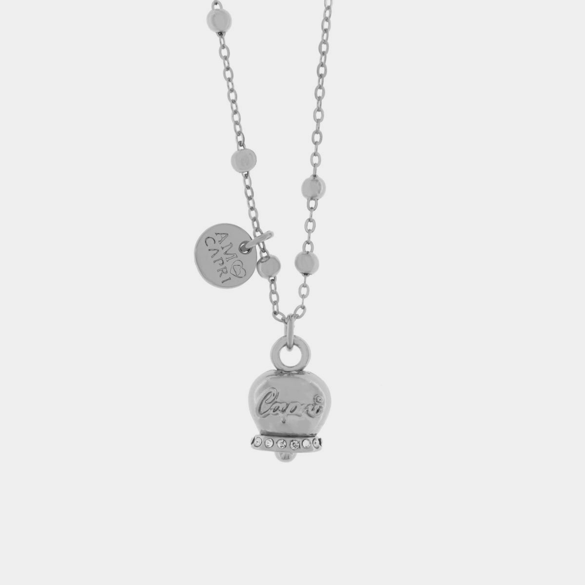 Collana in Metallo con campanella portafortuna pendente impreziosita da cristalli bianchi e scirtta Capri a rilievo