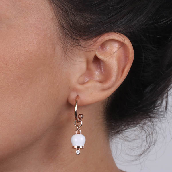 Metal earrings with a circle, with a pendant charm bell, embellished with white enamel and crystals