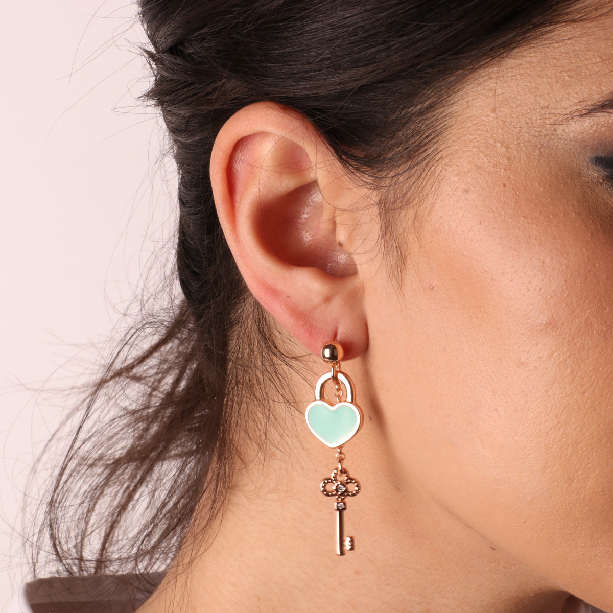 Metal earrings with heart and key padlock with turquoise nail polish and white crystals