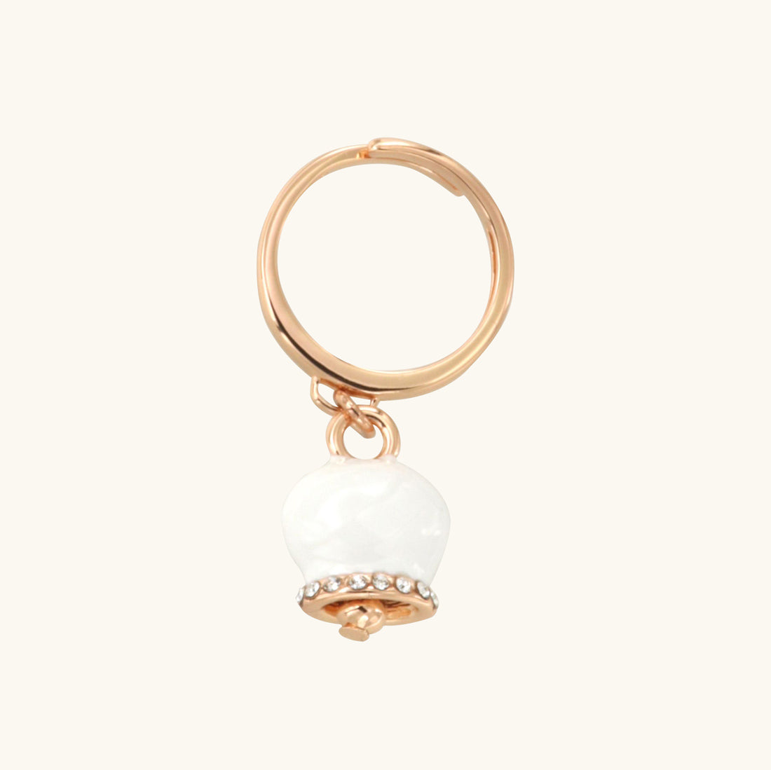 Metal ring with charming bell, embellished with white enamel and crystals