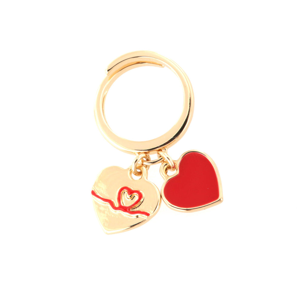 Metal ring with pendant charms, heart with in relief thread in red enamel and heart covered with enamel