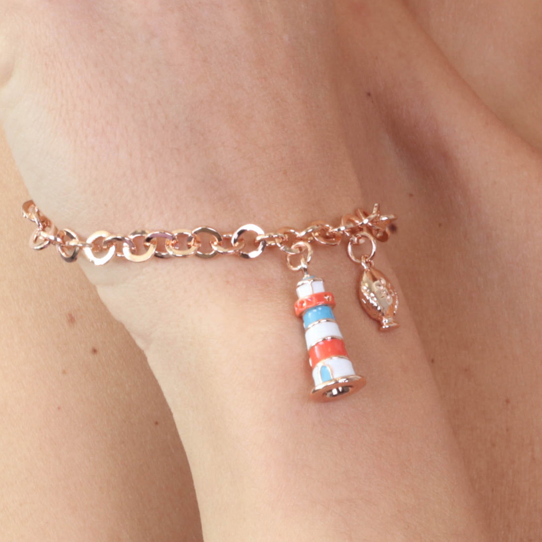 Metal bracelet with pendant lighthouse pendant, embellished with colored glazes and small pump on the side