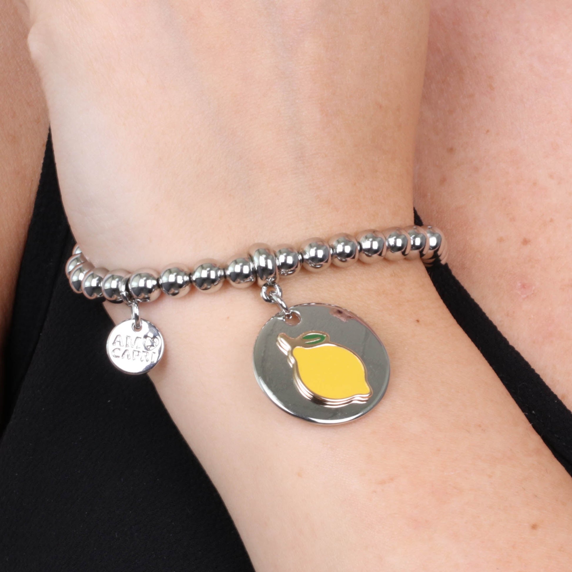 Metal bracelet spheres, with a lemon symbol medallion with colored glazes