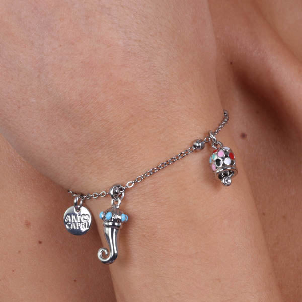 Campanella metal bracelet and horn pendants embellished with colored glazes