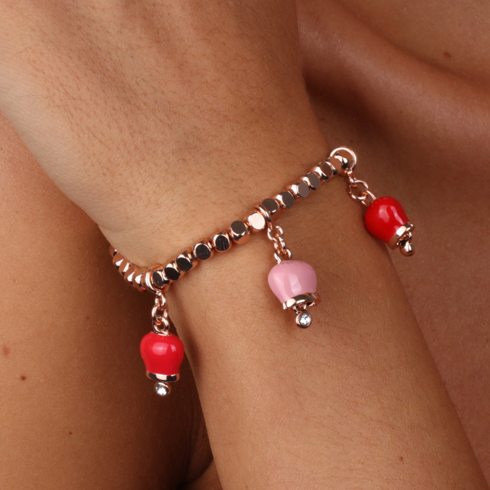 Metal bracelet with three red and pink bells
