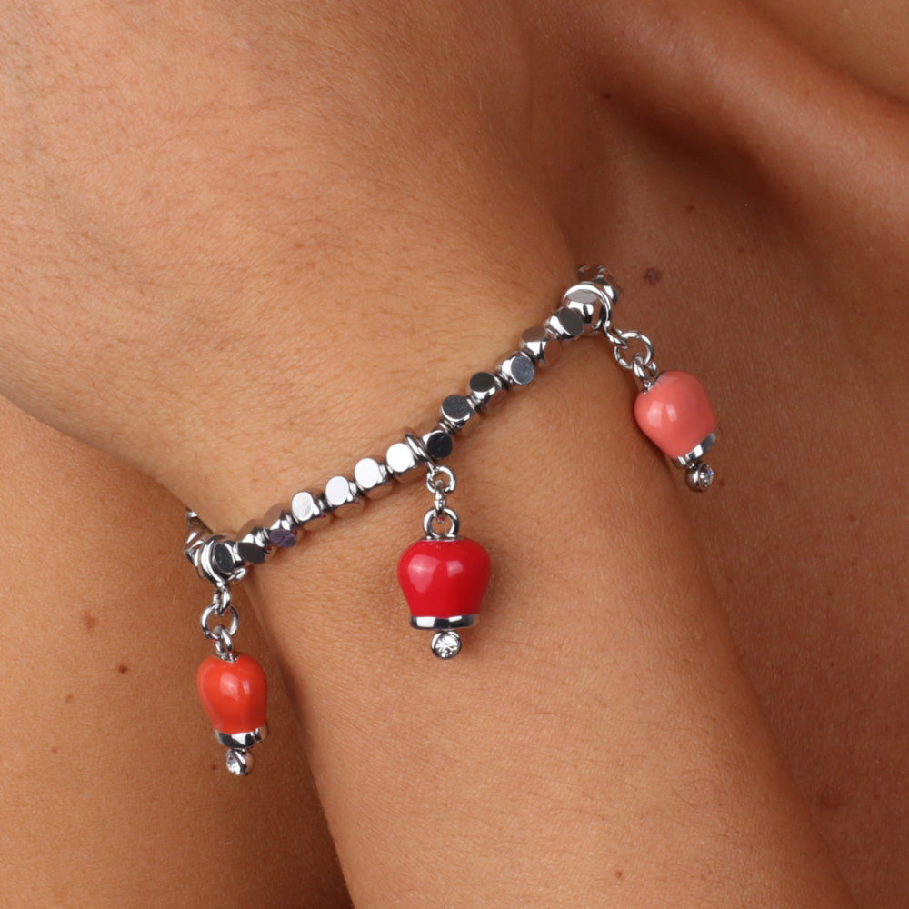 Metal bracelet with three red colored bells and white crystals