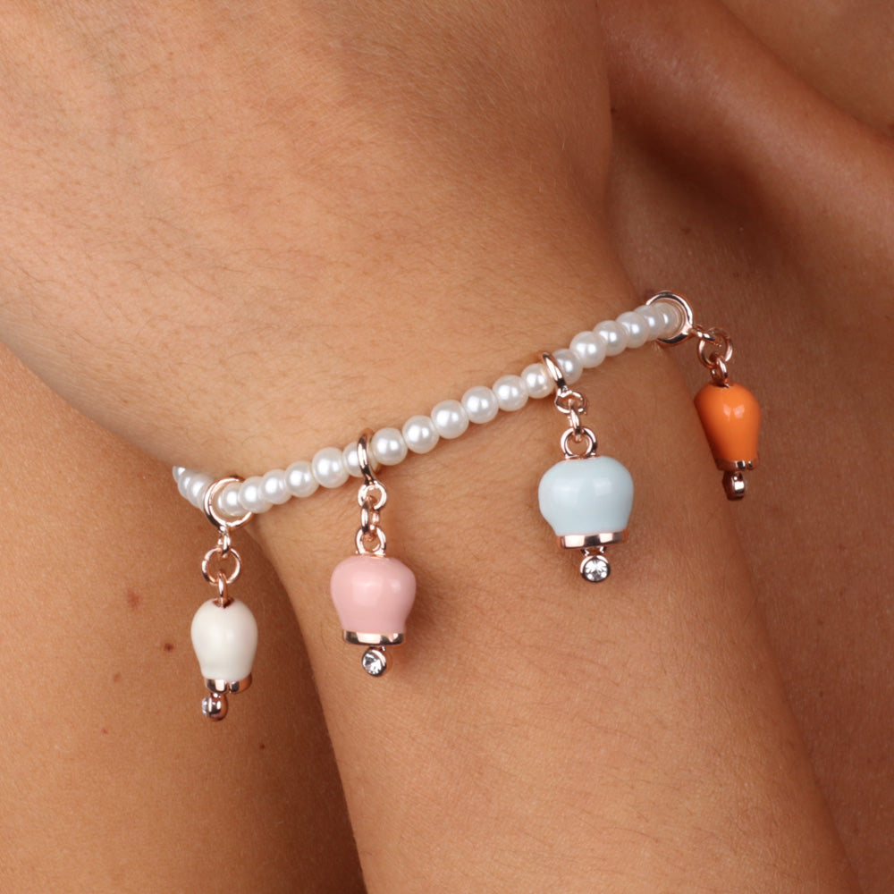 Metal bracelet with four colored bells: pink, white, coral, blue
