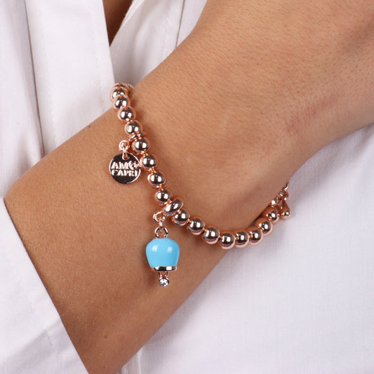 Metal bracelet of ball jersey, with a pendant charms bell, embellished with turquoise enamel and light point