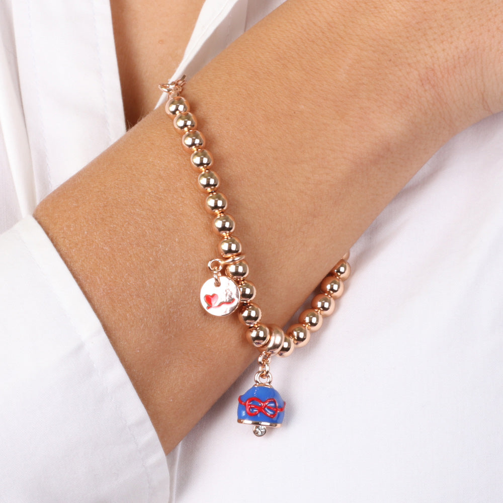 Metal bracelet spheres shirt, with blue nail polish bell pendant embellished with a red thread bow