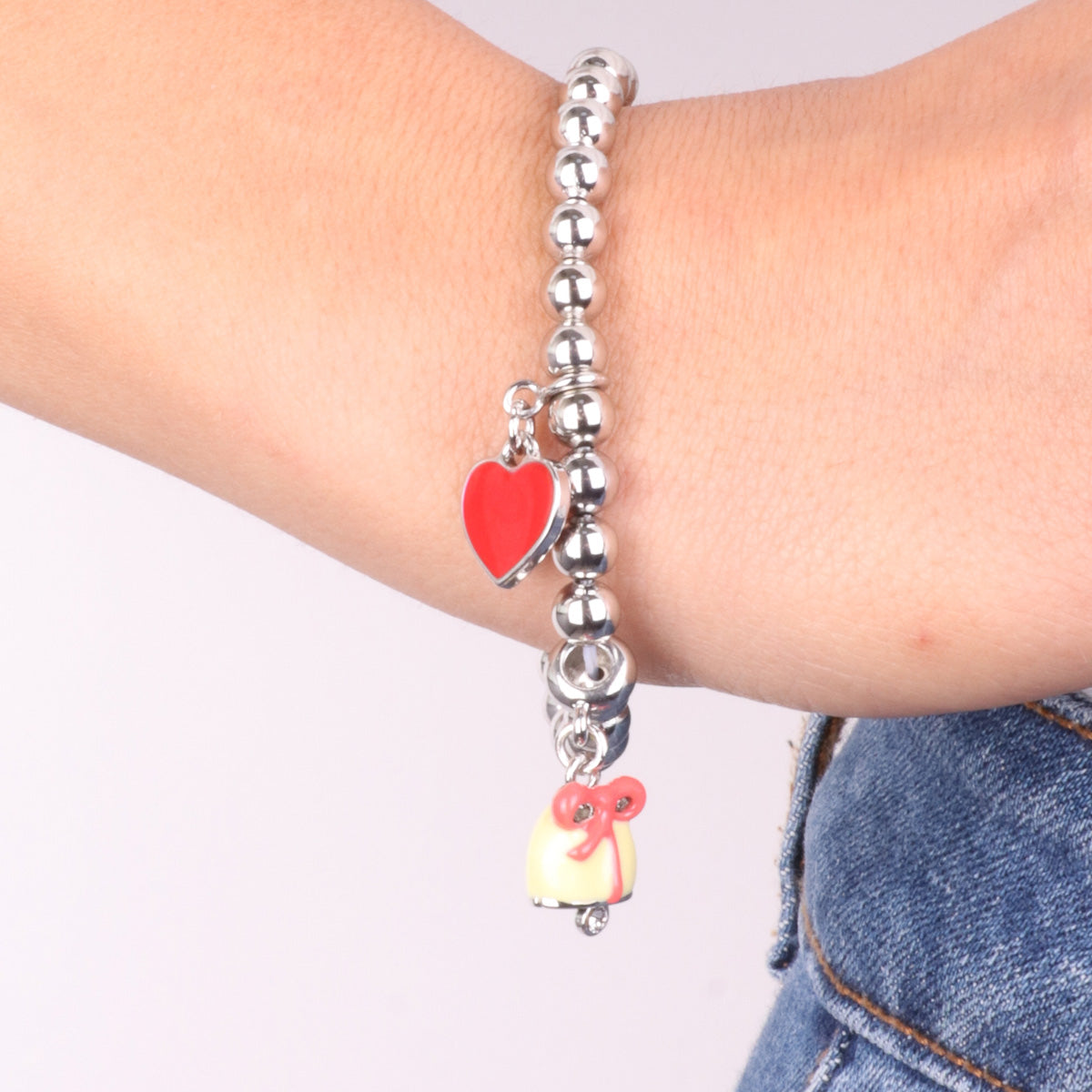 Metal bracelet yellow bell pendant with bow and red heart