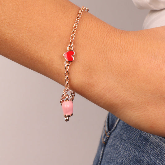 Metal bracelet with red heart and pendant charm bell, embellished with pink enamel and light point