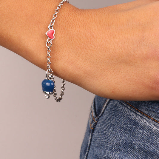 Metal bracelet with red heart and pendant charm bell, embellished with blue enamel and light point