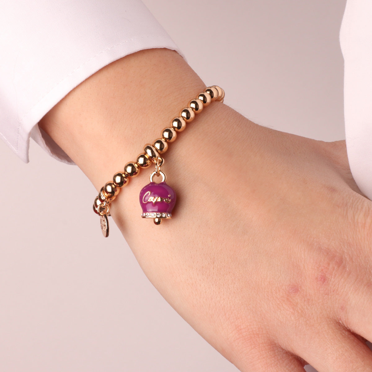 Metal bracelet with bell pendant purple with capri writing