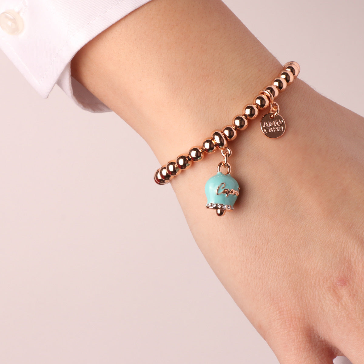 Metal bracelet with turquoise charcoal bell with capri writing