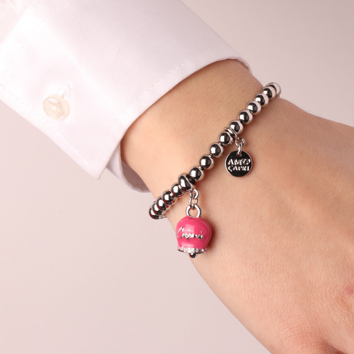 Metal bracelet with fuchsia bell, with Capri writing and white crystals