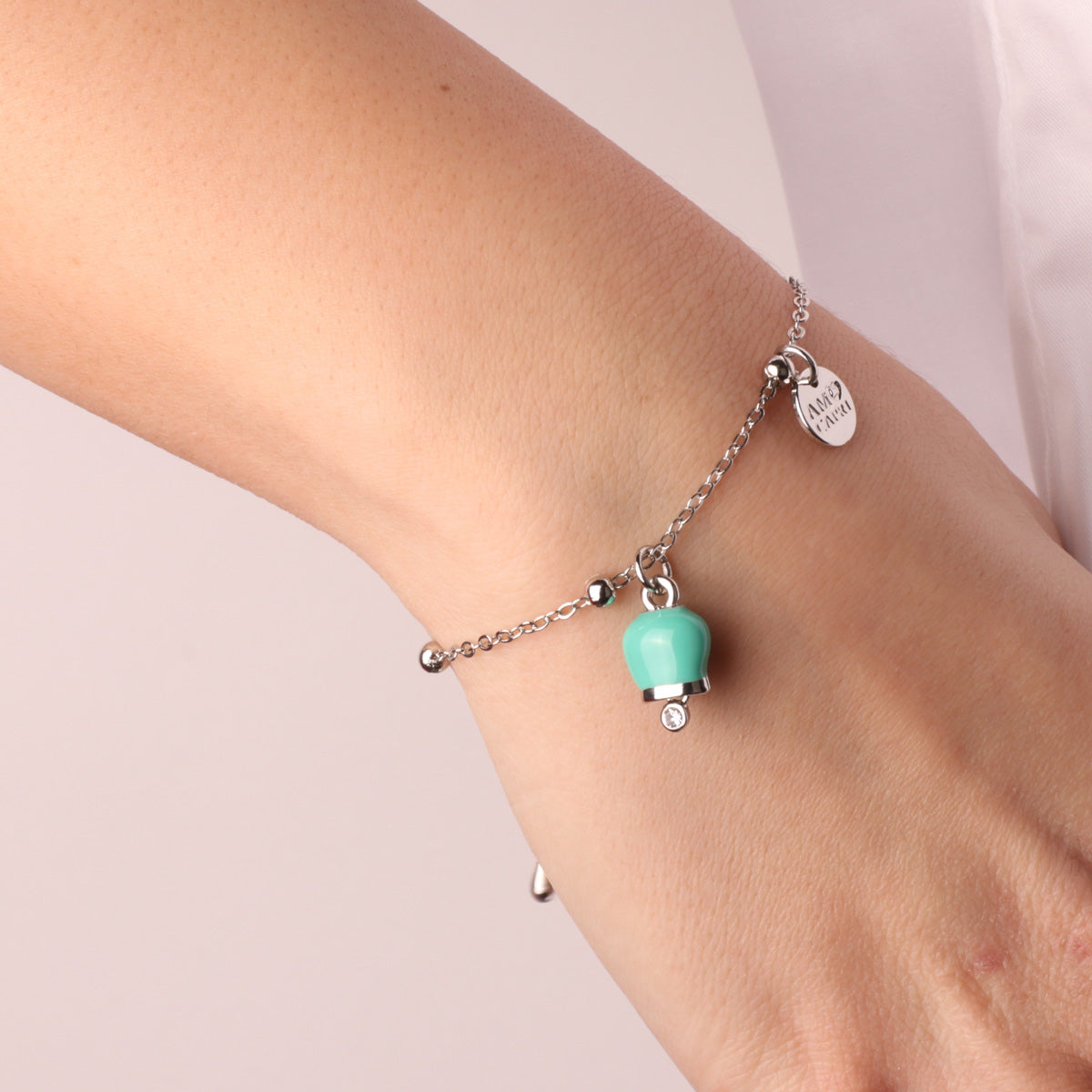 Metal bracelet with pendant lucky charm, embellished with water -green enamel and light point