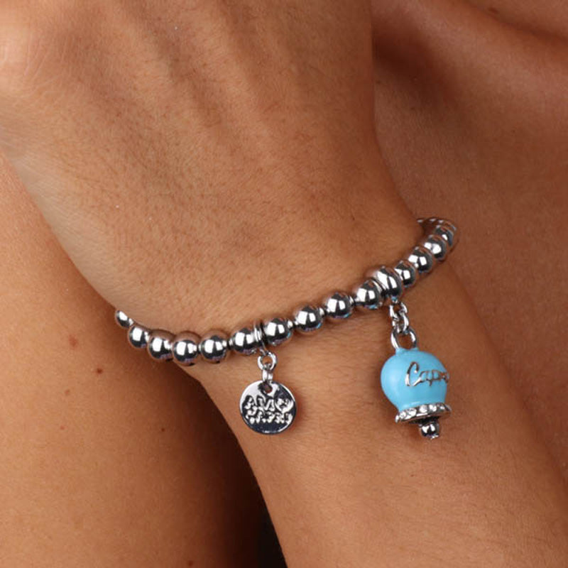 Metal bracelet spheres shirt, with written bell pendant flap enhanced by turquoise crystals and nail polish