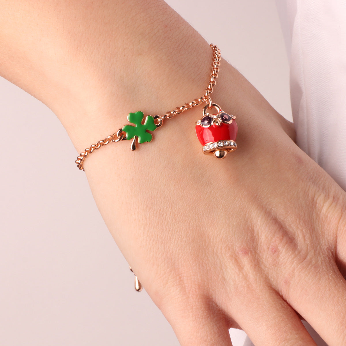 Metal bracelet with four -leaf clover and owl charming bell with red nail polish and white crystals